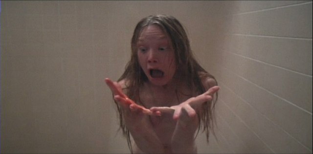 Carrie in the shower experiencing real-life horrors.